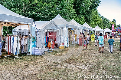03.08.2022 - Jambville, France: Market at yoga festival, vintage stuff, flea market, yoga supplies, white tents. Editorial Stock Photo