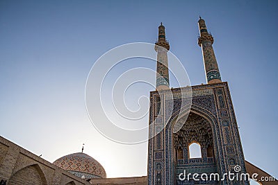 Jameh mosque, with its distinctive tiles minarets, seen at sunset. Jameh mosque is one of the symbols of the city of Yazd Stock Photo