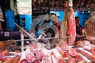 Jamon Seller in La Boqueria Market in Barcelona, Spain Editorial Stock Photo