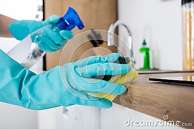 Janitor Cleaning Kitchen Worktop Stock Photo