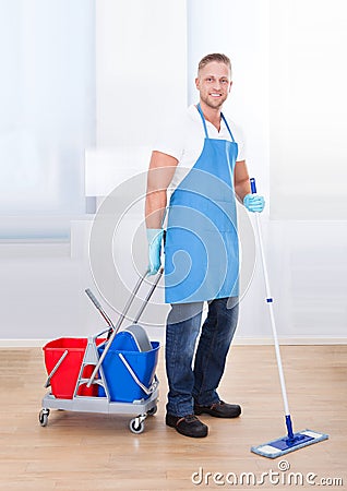 Janitor cleaning wooden floors Stock Photo