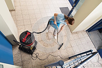 Janitor Vacuuming Floor Stock Photo