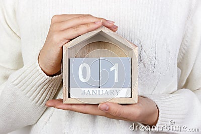 January 1 in the calendar. the girl is holding a wooden calendar. New Year. World Day of Peace. Feast of Mary Stock Photo