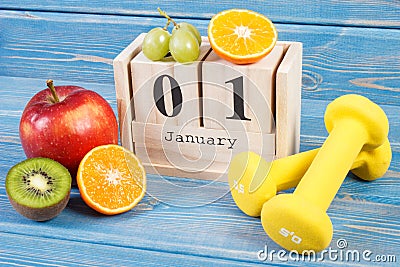 January 1 on cube calendar, fruits and dumbbells, new years resolutions concept Stock Photo