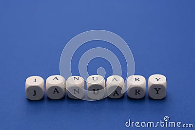 January lettering. Wooden blocks with january word over clasic blue blackground. Copy space Stock Photo