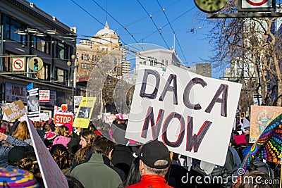 `Daca now` sign carried by a participant at the Women`s March Editorial Stock Photo