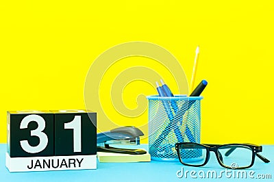 January 31st. Day 31 of january month, calendar on yellow background with office supplies. Winter time Stock Photo
