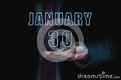 january 30th. Day 30 of month, announcement of date of business meeting or event. businessman holds the name of the month and day Stock Photo