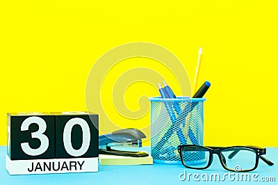 January 30th. Day 30 of january month, calendar on yellow background with office supplies. Winter time Stock Photo
