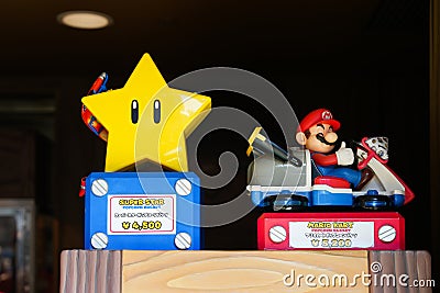 Japan - April 03, 2023: Super Star and Mario Kart popcorn bucket light up in the dark included caramel peach and mushroom cream Editorial Stock Photo