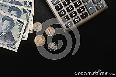 Japan currency paper banknote and coins on dark background, bank Stock Photo