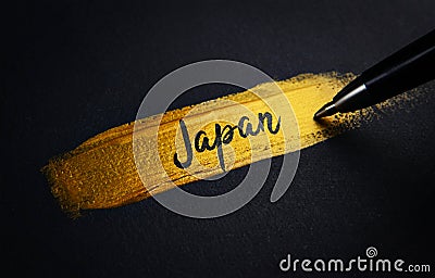 Japan Handwriting Text on Golden Paint Brush Stroke Stock Photo