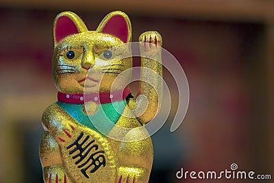 Japan lucky cat or Maneki Neko with Japanese characters mean Goo Stock Photo