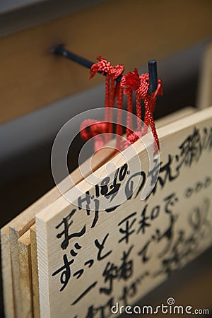 Japan Takayama Small wooden plaques with prayers and wishes (Ema) hanging on hook Editorial Stock Photo