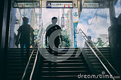 Japan man walking out of train station Editorial Stock Photo