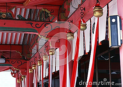 Japanese architectural decorative items with bells and red cloth Stock Photo