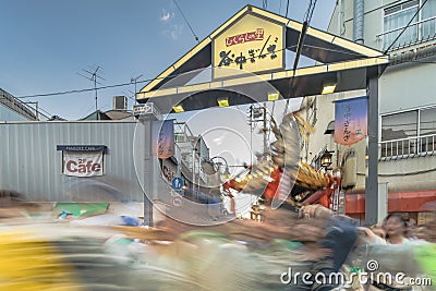 Japanese bear Shinto shrine mikoshi on their shoulders during the Obon festival in the retro old-fashionned shopping street Yanaka Editorial Stock Photo