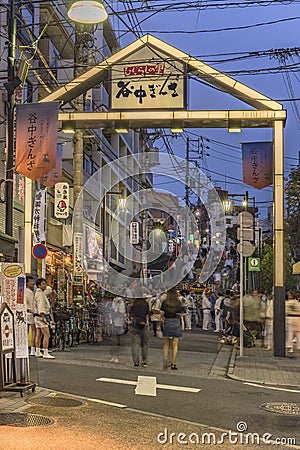 Japanese bear Shinto shrine mikoshi on their shoulders during the Obon festival in the retro old-fashionned shopping street Yanaka Editorial Stock Photo