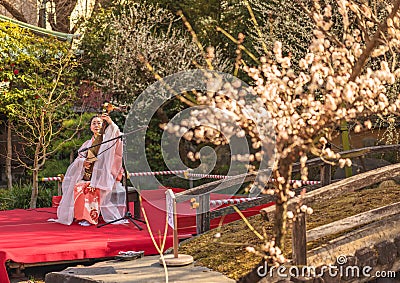 Japanese biwa lute demonstration by a Japanese woman in a kimono in the Yushima Tenmangu temple Editorial Stock Photo