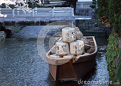 Japanese boat with goods in a river tied to the bank with a rope background Editorial Stock Photo