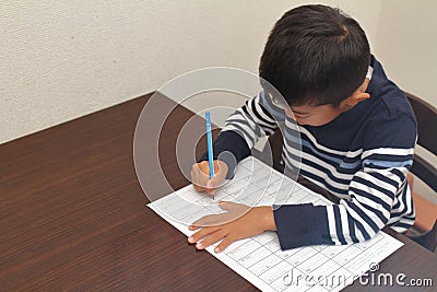 Japanese boy doing homework Stock Photo