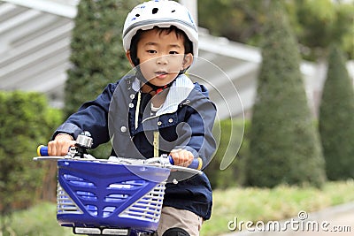 Japanese boy riding on the bicycle Stock Photo