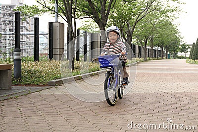 Japanese boy riding on the bicycle Stock Photo