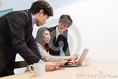 Japanese business person checking internet web site with PC Stock Photo