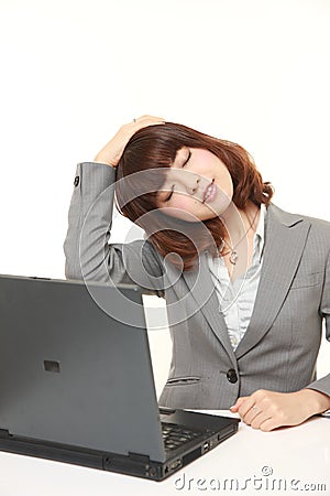 Japanese businesswoman doing neck stretch Stock Photo