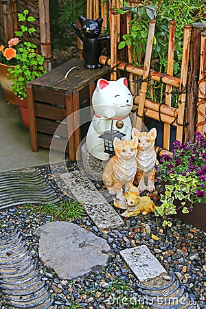 Japanese ceramic cats as lucky charm to decorate the zen styled Stock Photo