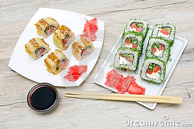 Japanese cuisine - different rolls on the plate on a wooden table Stock Photo