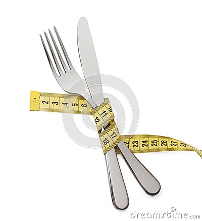 Japanese diet for weight loss. The fork and knife are wrapped in yellow measuring tape on white isolated Stock Photo