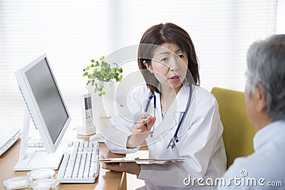 Japanese female doctor examining Stock Photo