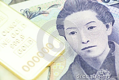 Japanese five thousand yen bill, a macro close-up with gold bullion. Stock Photo