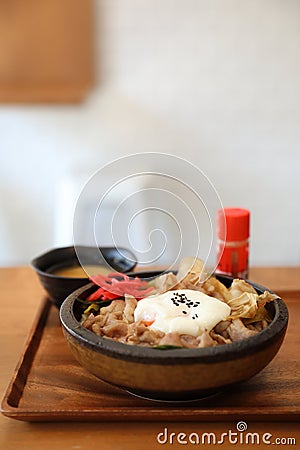 Japanese food Gyudon Japanese beef on rice bowl topped with egg on wooden tray Stock Photo