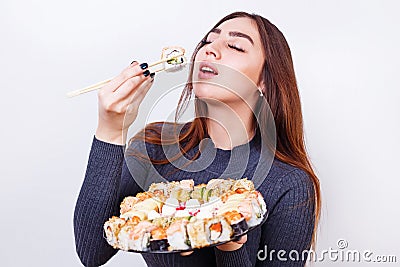 Japanese food, restaurant concept. Young beautiful woman enjoy e Stock Photo