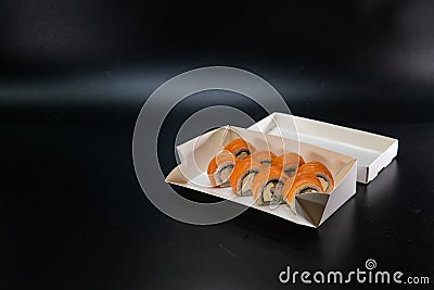 Japanese food, sushi roll cardboard box for fast food. White paper food box. Cardboard products. delivery box. Copy space. Black Stock Photo