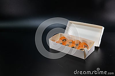 Japanese food, sushi roll cardboard box for fast food. White paper food box. Cardboard products. delivery box. Copy space. Black Stock Photo