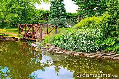 Japanese garden, wooden bridge over the pond, Japanese garden design, summer garden in Japanese style Stock Photo