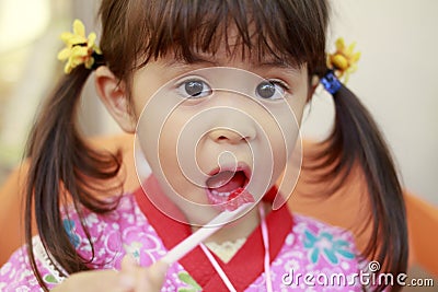 Japanese girl eating shaved ice in Yukata Stock Photo