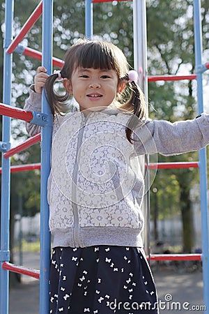 Japanese girl on the jungle gym Stock Photo