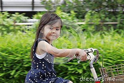 Japanese girl riding on the bicycle Stock Photo