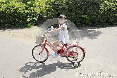 Japanese girl riding on the bicycle Stock Photo