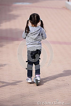 Japanese girl riding on a scooter Stock Photo