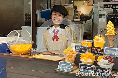 Japanese girl selling mango ice-cream. Editorial Stock Photo