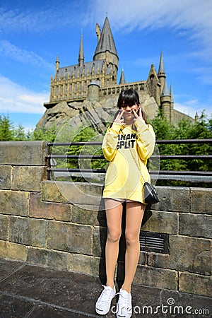 Japanese girl taking photo at The Hogwarts castle Editorial Stock Photo