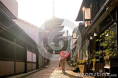 Japanese girl in Yukata with red umbrella in old town Kyoto Stock Photo