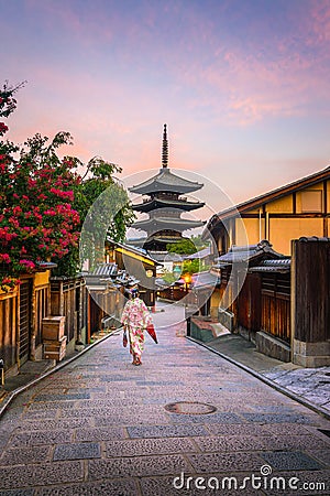 Japanese girl in Yukata with red umbrella in old town Kyoto Editorial Stock Photo