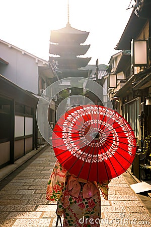 Japanese girl in Yukata with red umbrella in old town Kyoto Stock Photo