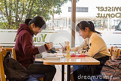 Japanese girls at a coffee shop. Editorial Stock Photo